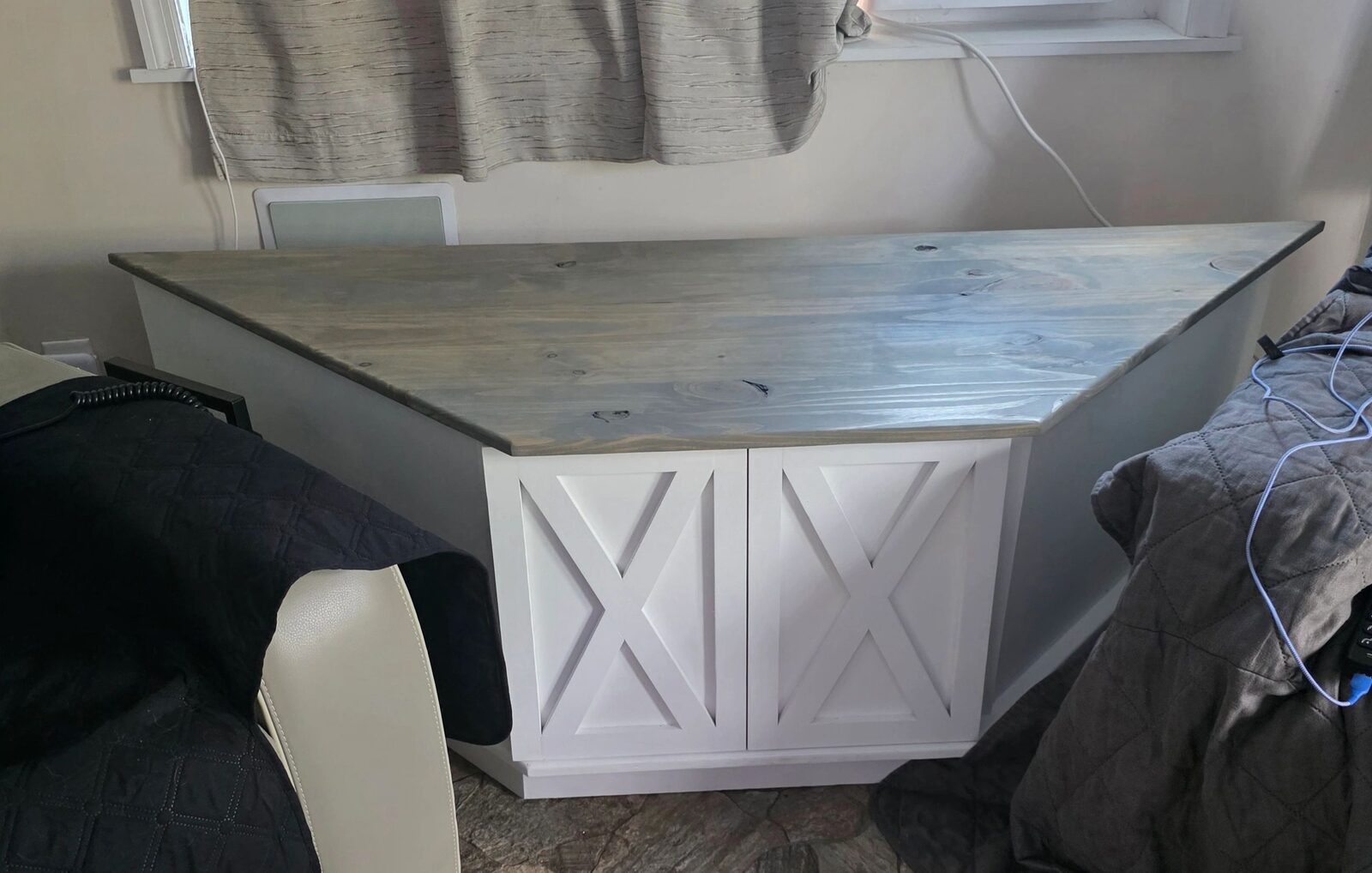 Special-size white cabinet with angled wood top and barn-style doors