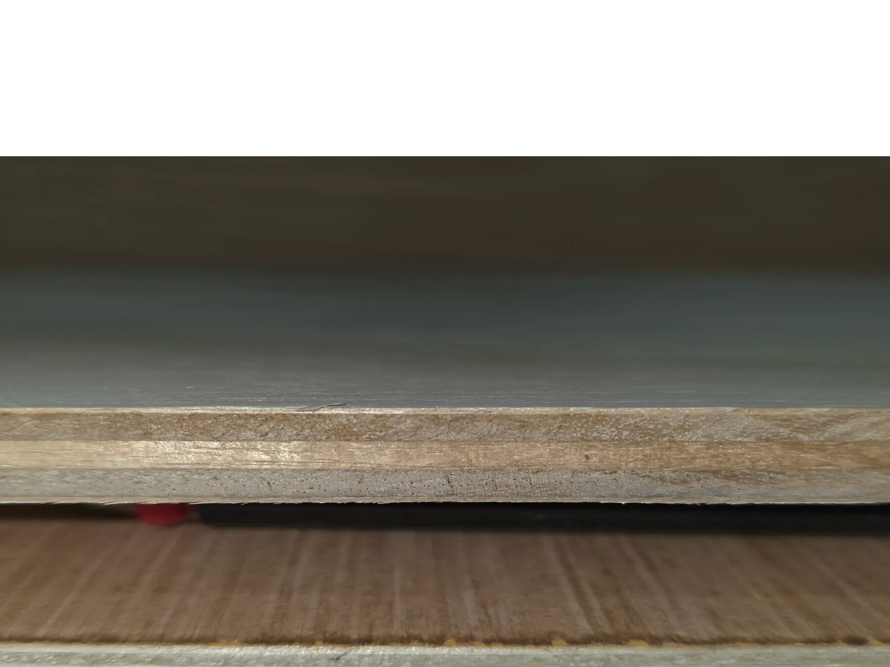 Centered close-up showing the layered edge of 1/2-inch plywood